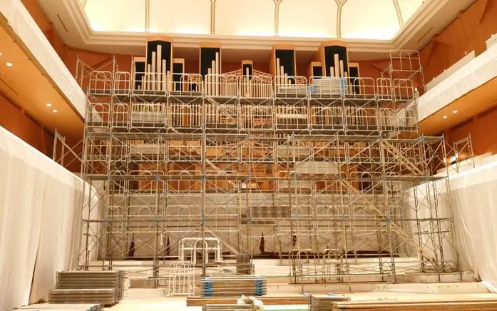 Installation process of understage machinery, involving structural work, equipment setup, and on-site testing.