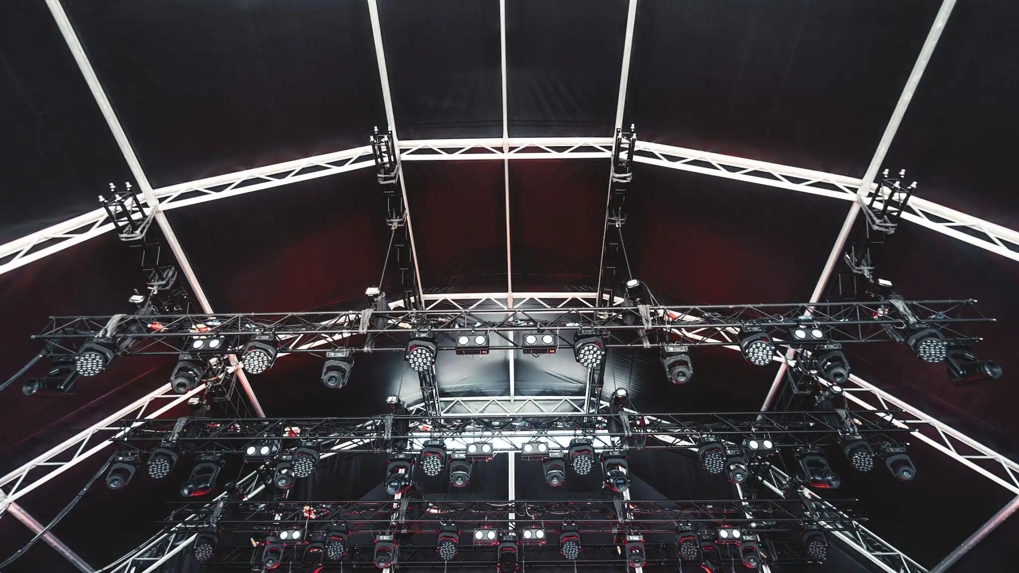 Large-scale concert stage equipped with advanced machinery systems, including rigging, lighting, and automated platforms for dynamic live performances.
