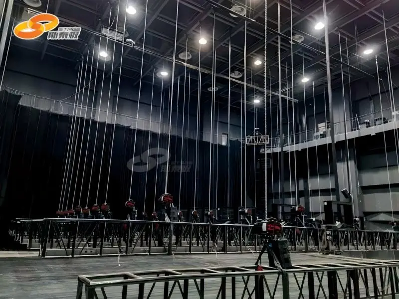 Technician inspecting stage rigging and lifting equipment to ensure compliance with safety standards and certifications. Technician inspecting stage rigging and lifting equipment to ensure compliance with safety standards and certifications.